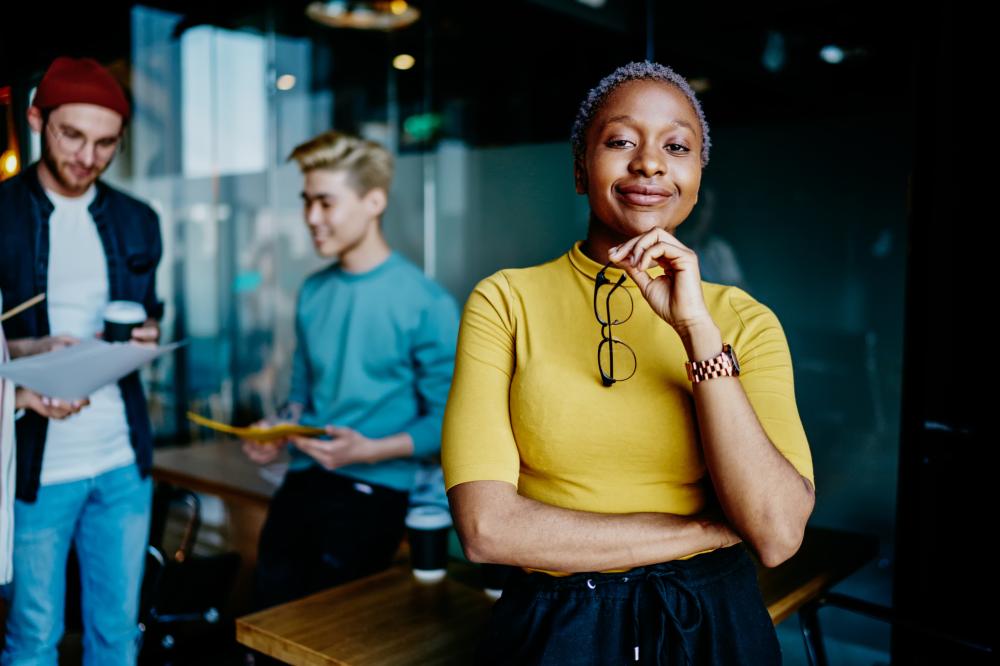 Confident businesswoman standing in front of colleagues
