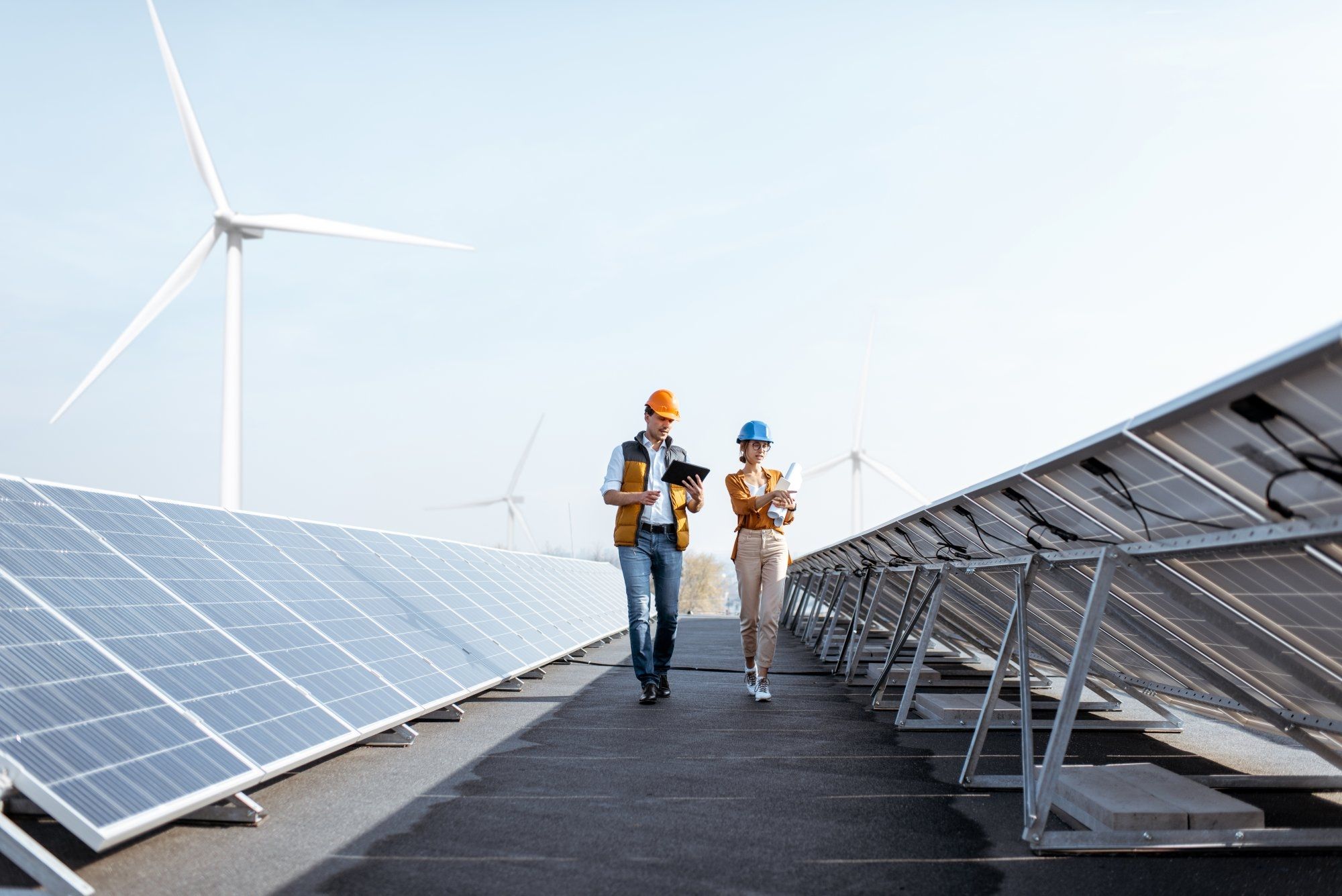 iso-50001-certification-dqs-two persons using solar panels and wind turbine
