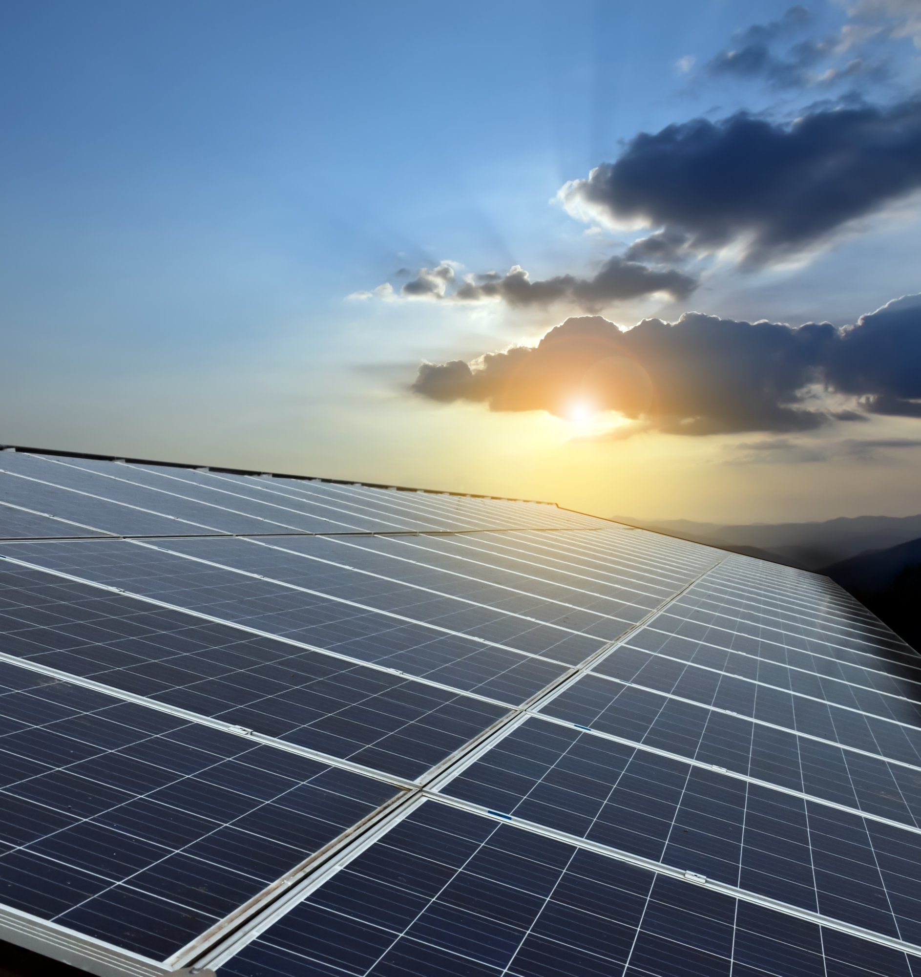 implement-energy-management-dqs-photovoltaic systems on a roof at sunset