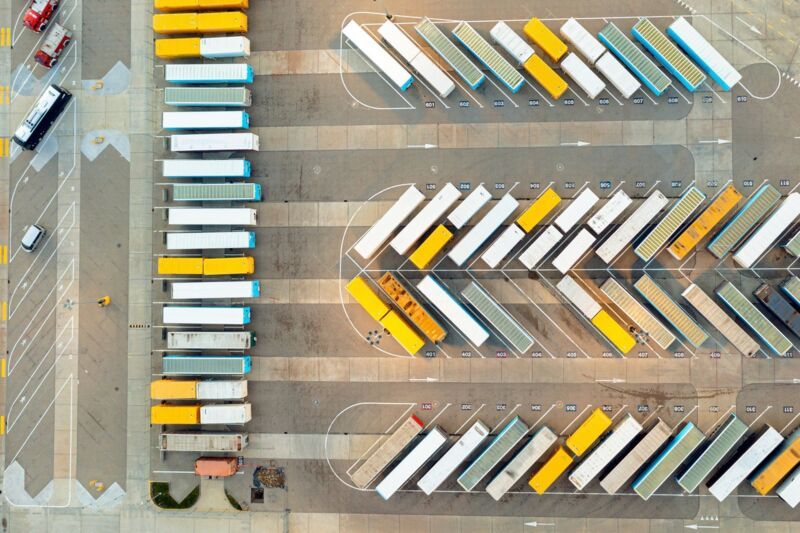 Many trucks and trailers are parked at the base, logistics and production center.